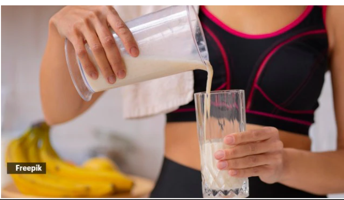 Various forms of whey protein powders in containers with a measuring scoop